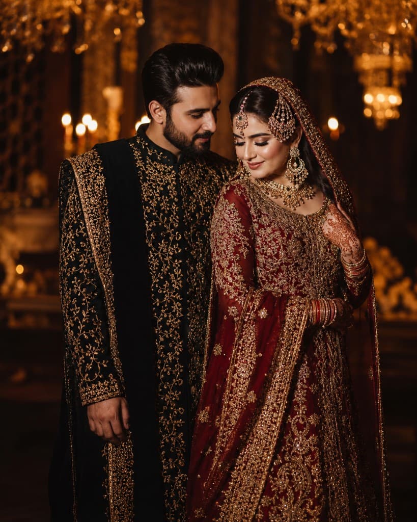 South Asian bride and groom in traditional wedding attire, sharing a romantic moment